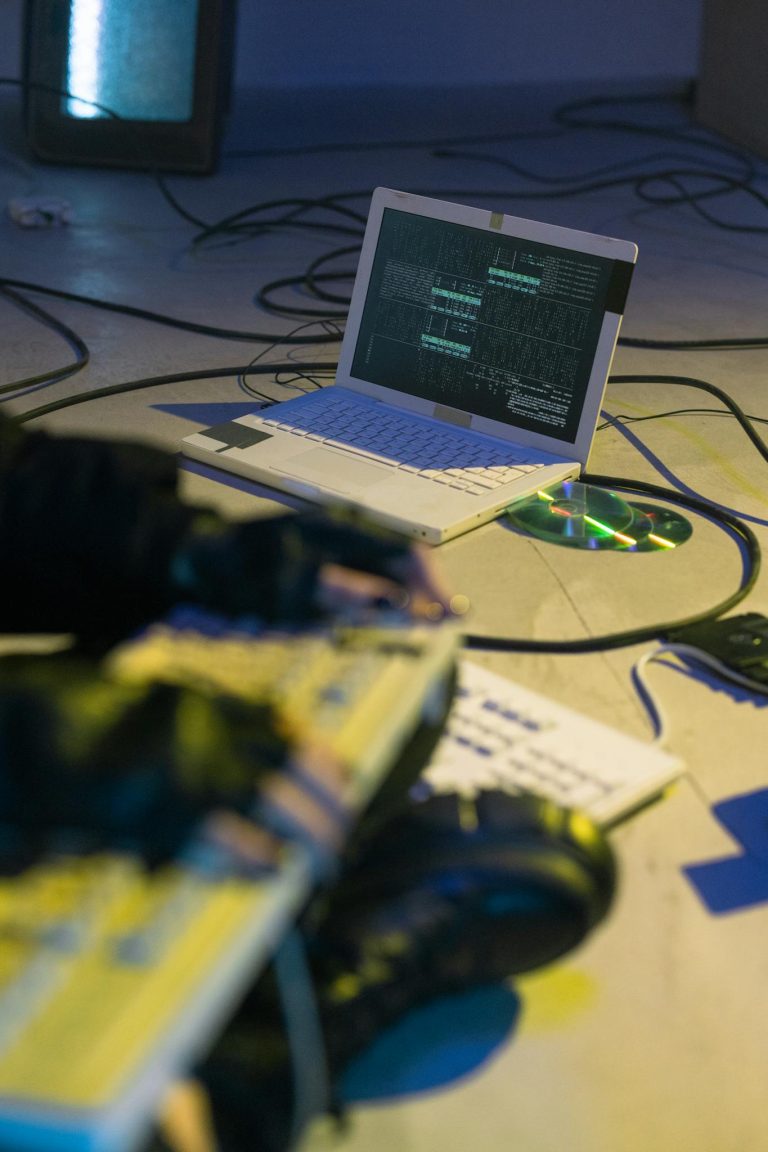 Laptop with coding software on-screen, symbolizing cybersecurity and tech innovation.